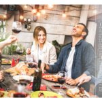 People gathered around an outdoor table laughing