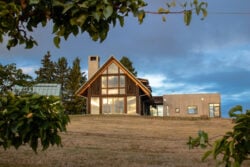 View of large bespoke home from the apple orchard